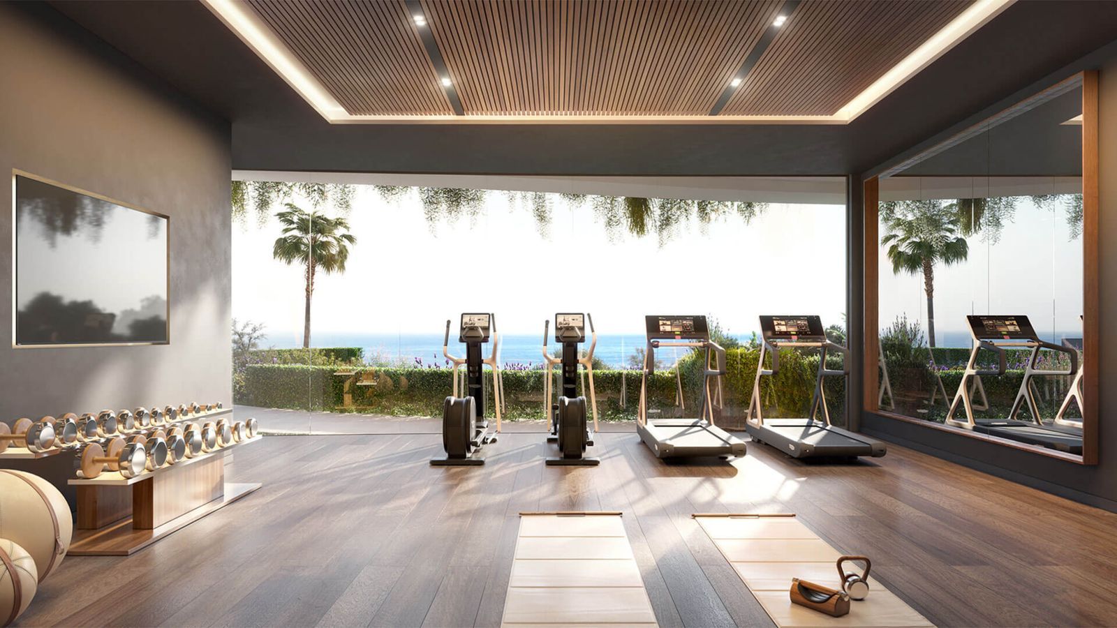 Moderne sportschool met uitzicht op de oceaan en trainingsapparatuur.